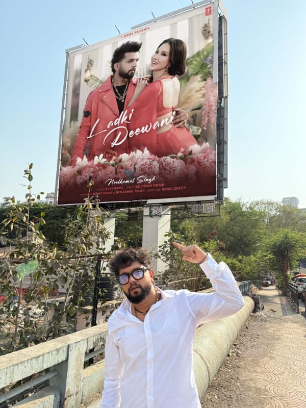 Neelkamal Singh out side with song promotion poster with (in poster sunny leone)