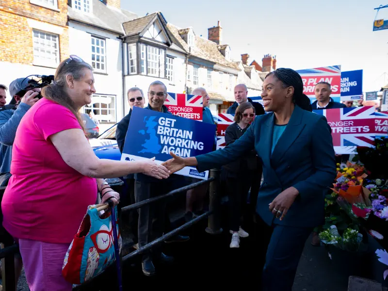 Kemi Badenoch - Personal Life, Age, Husband, Politician 4 Kemi Badenoch meeting a local resident on a street campaign in the UK for the 'Get Britain Working Again' initiative