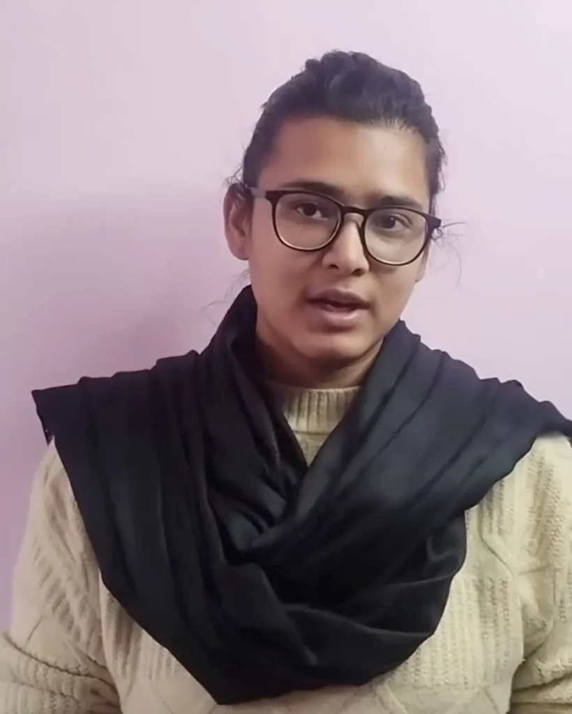 Neha Bora wearing AISA’s black scarf during a student movement protest