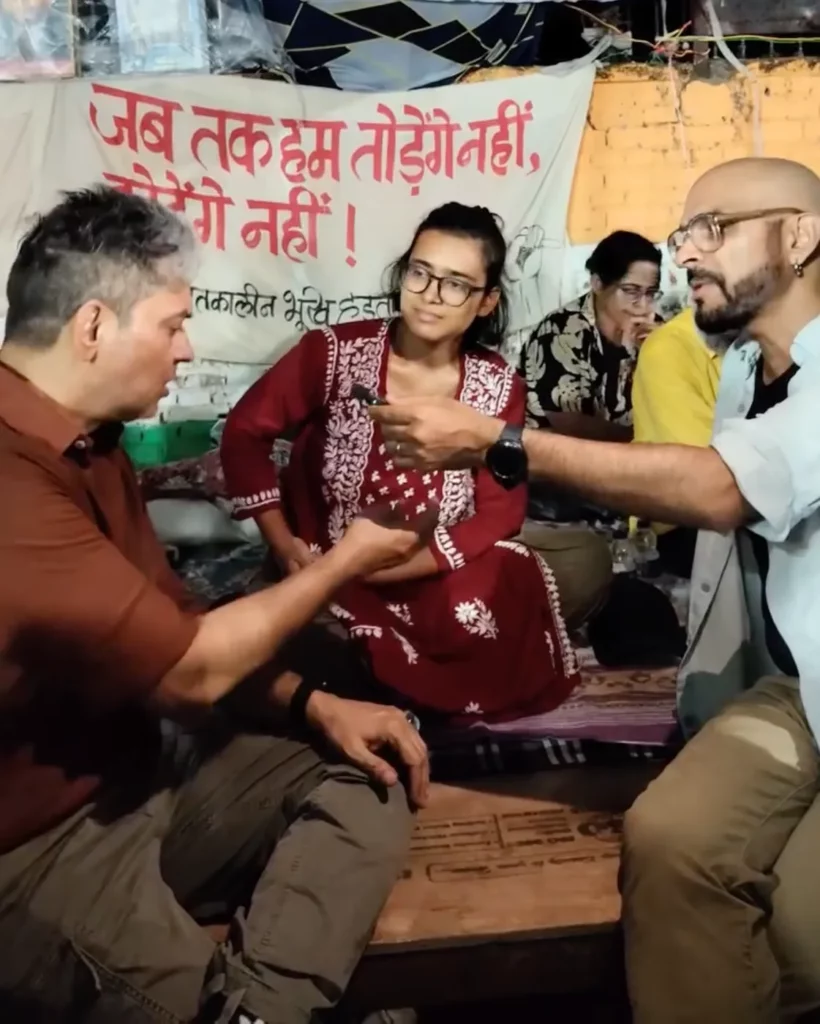 Raghu Ram speaks with Neha Bora during her hunger strike at Jantar Mantar