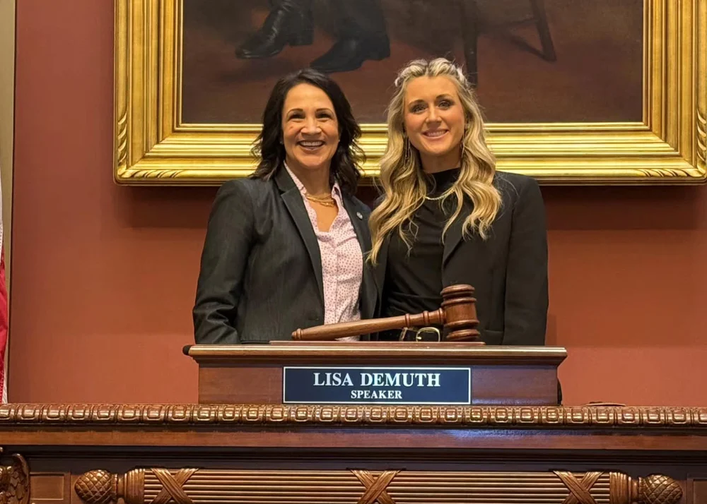 Lisa Demuth and Riley Gaines standing together at the Minnesota Capitol podium