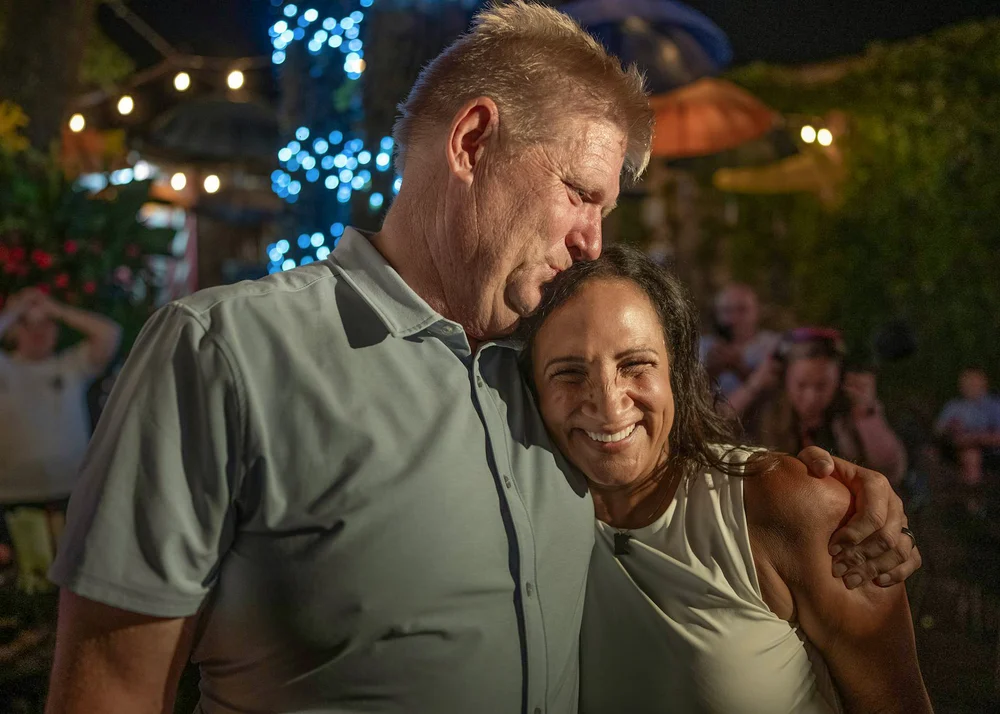 Lisa Demuth is embraced by her husband, Nick, as the results roll in during her election party at Burger Moe’s in St. Paul
