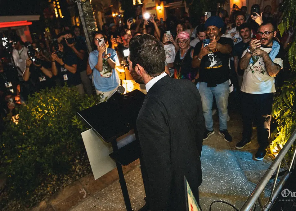 Oliver Larkin addresses supporters at the Chomp the Oligarchy rally in Fort Lauderdale alongside U.S. Representative Rashida Tlaib