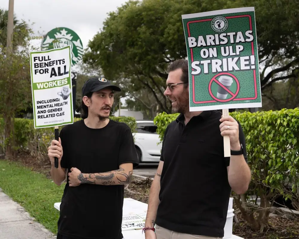 Oliver Larkin joins striking Starbucks baristas on the picket line during a unfair labor practice protest