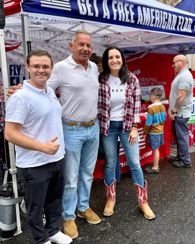 Congressional candidate Anthony DiLorenzo poses with campaign supporters at a Turning Point Action booth during the Cruising Downtown event in Manchester